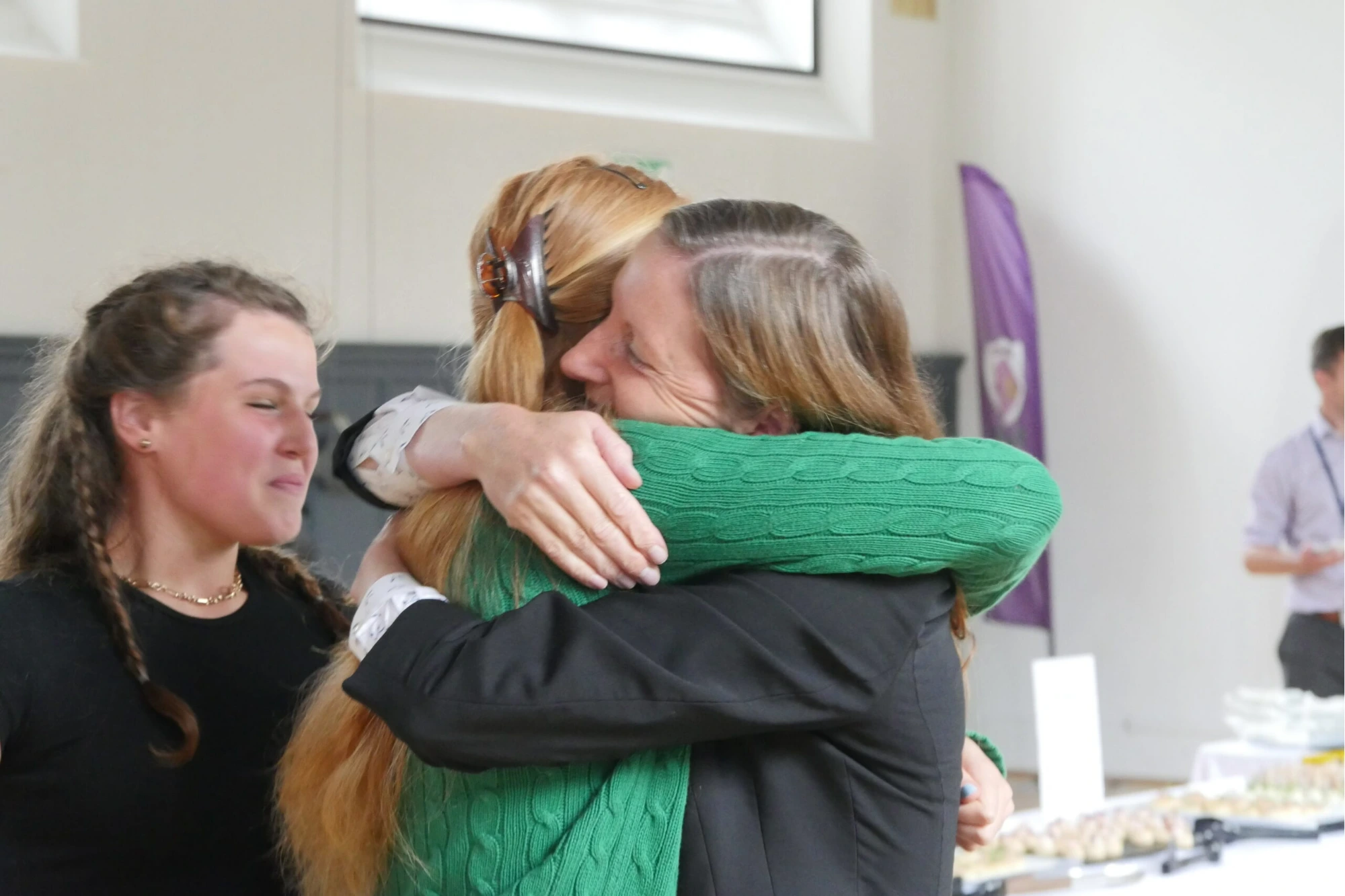 Parent and teacher hugging on GCSE results day