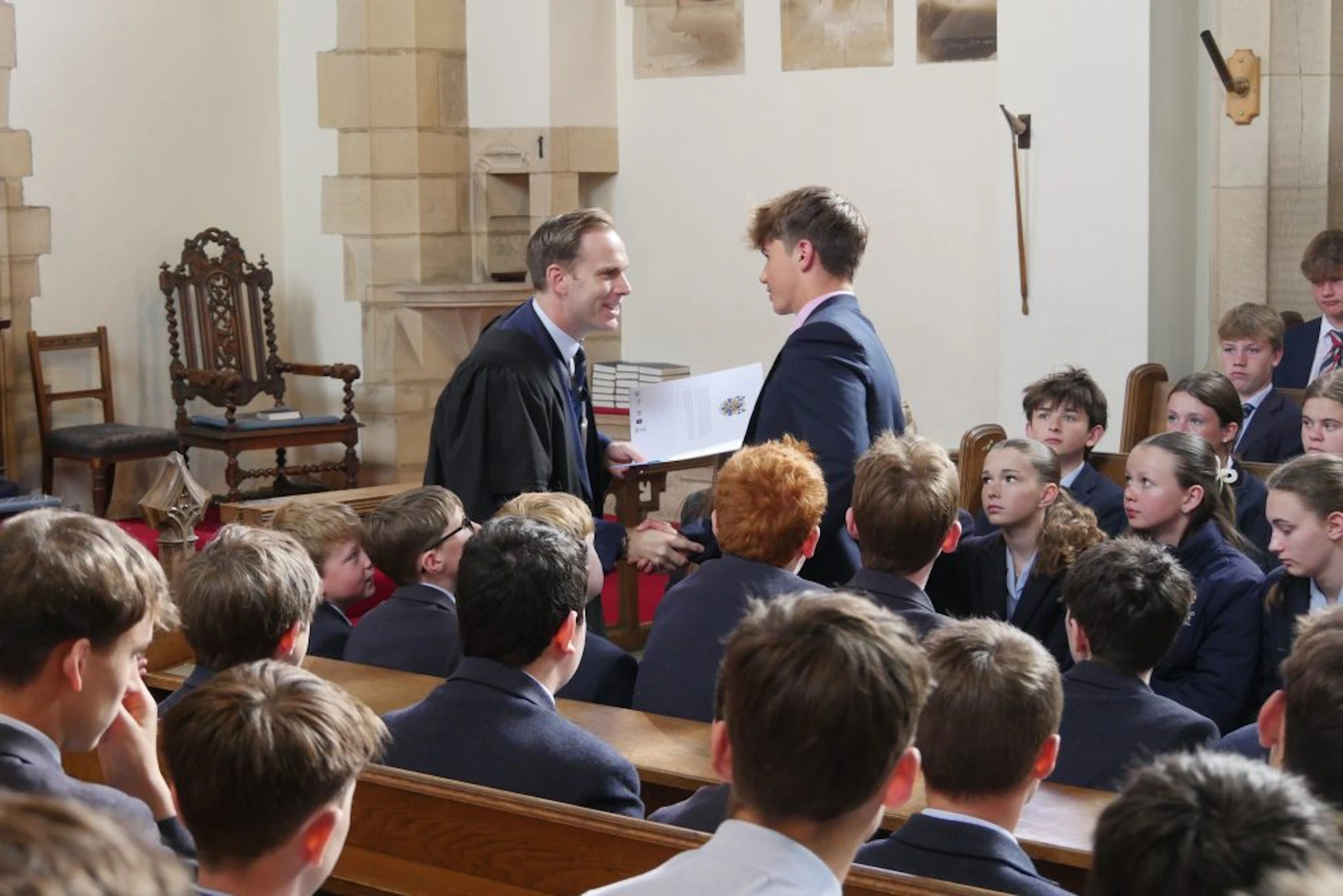 Barnard Castle School's principal David Cresswell shaking a pupil's hand during the assembly.