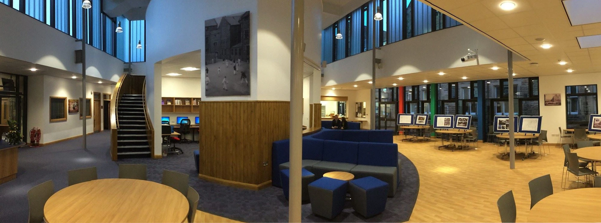 Barnard Castle School's Kenneth King Centre: a spacious room filled with numerous tables and chairs arranged for gatherings or events.