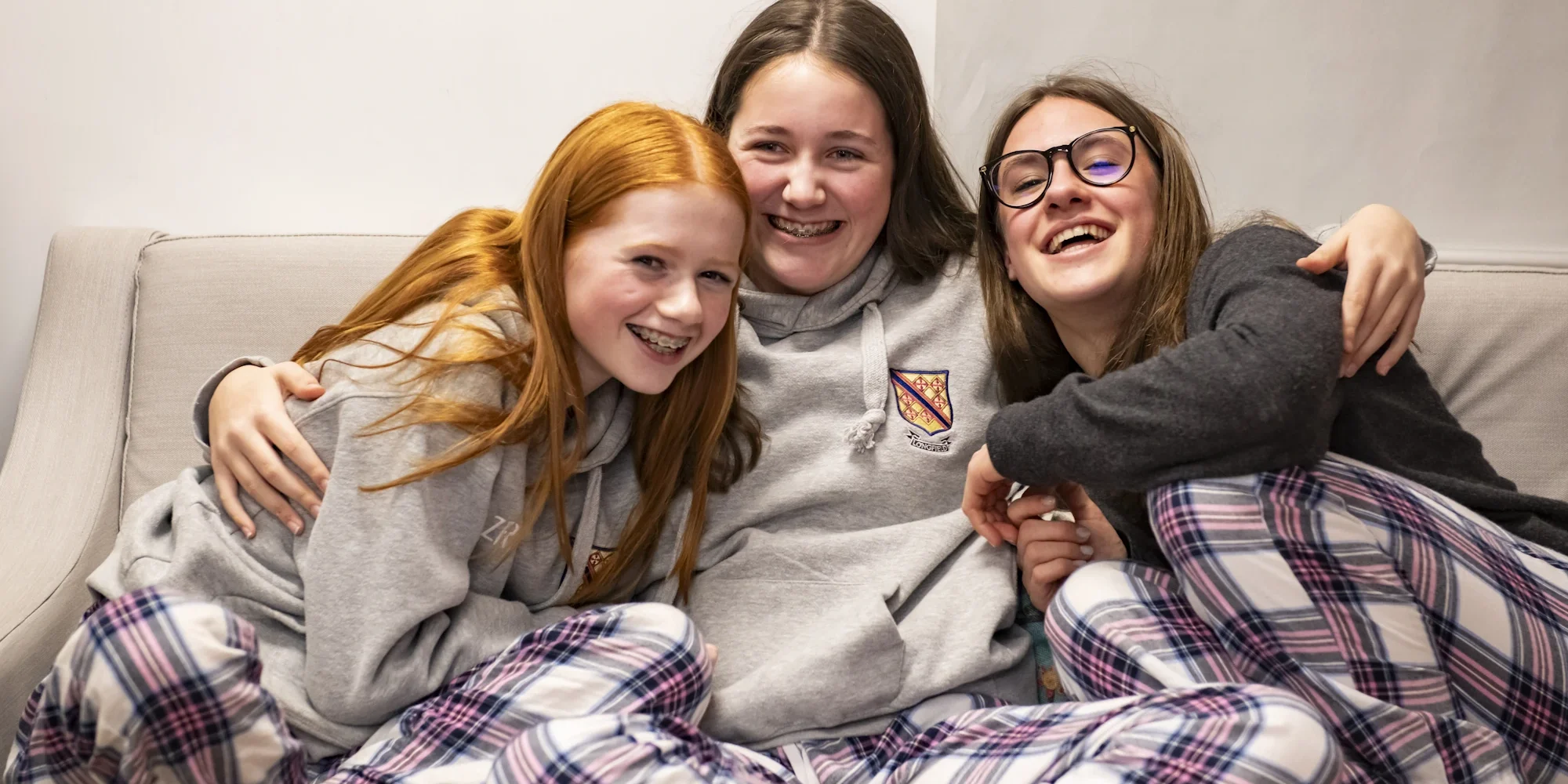 Barnard Castle School boarding pupils hugging sat together.