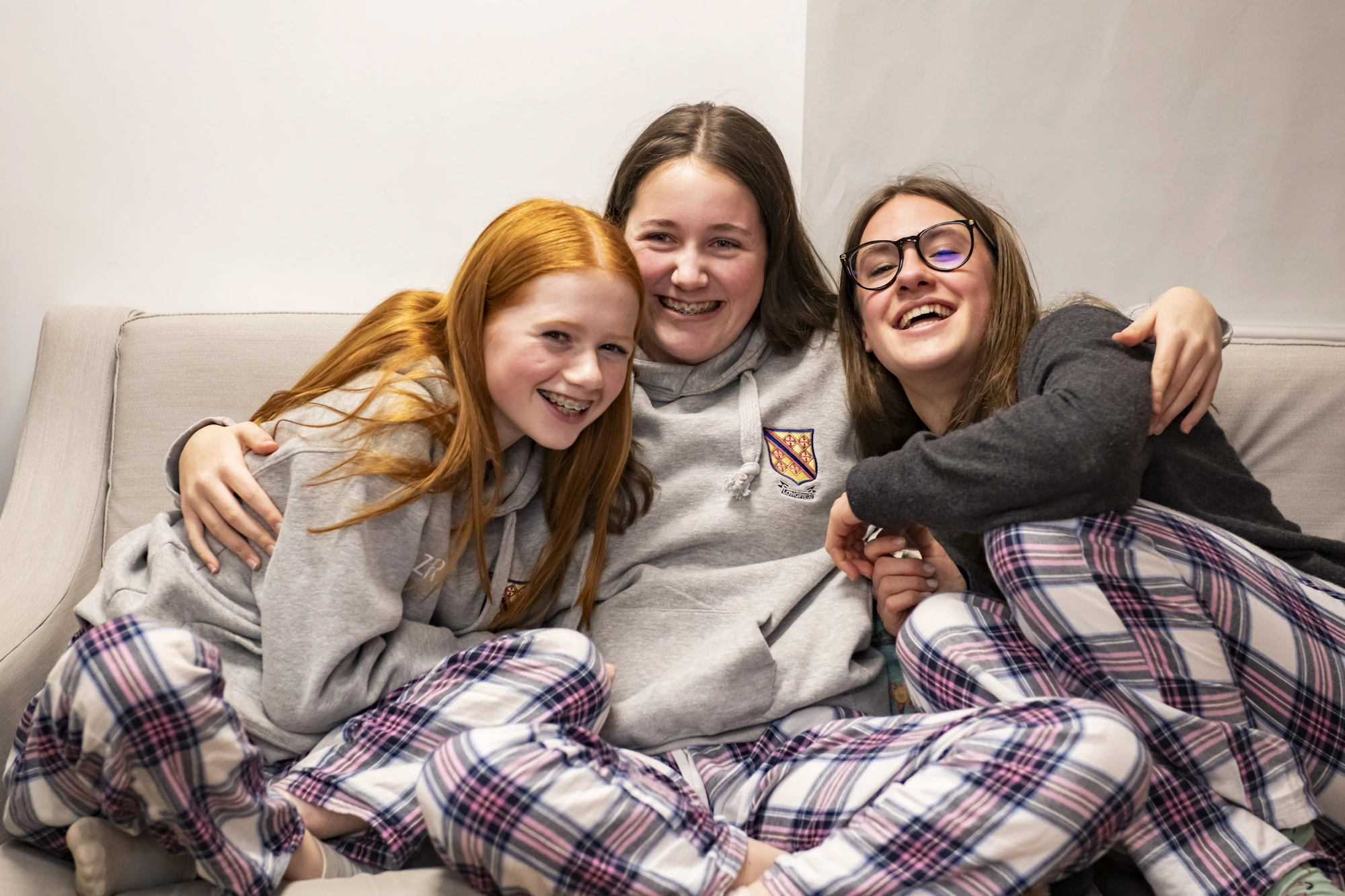 Barnard Castle School boarding pupils hugging sat together.