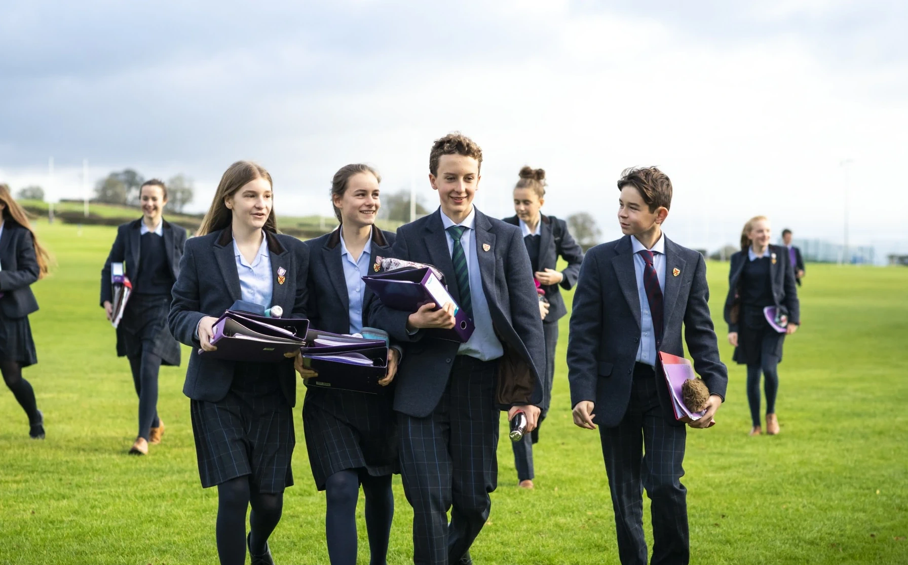 Barnard Castle School senior pupils walking with folders in their hands.