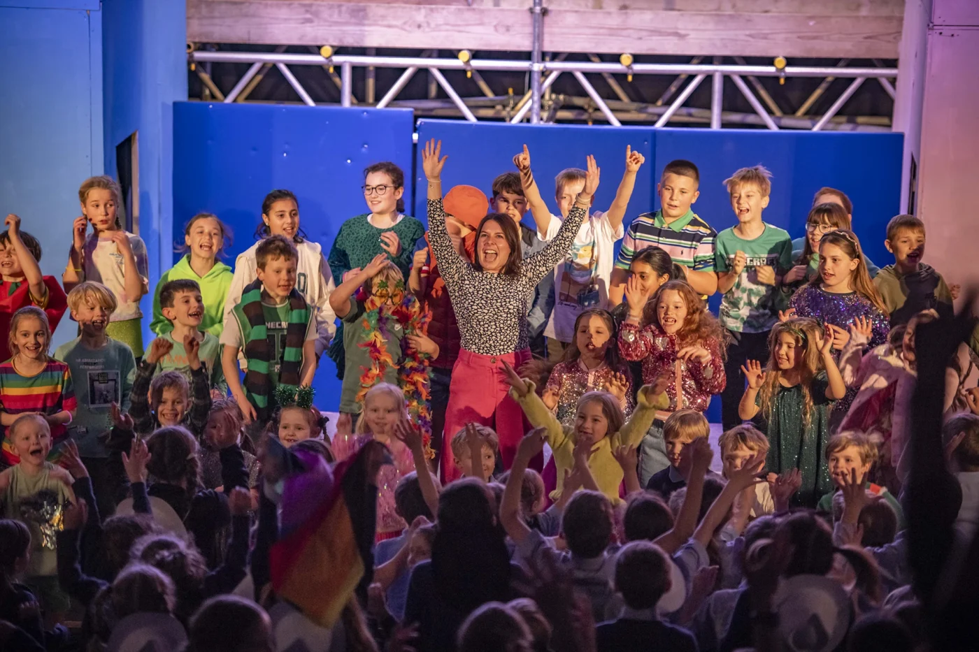 A teacher on stage with pupils during a production at Barnard Castle School.