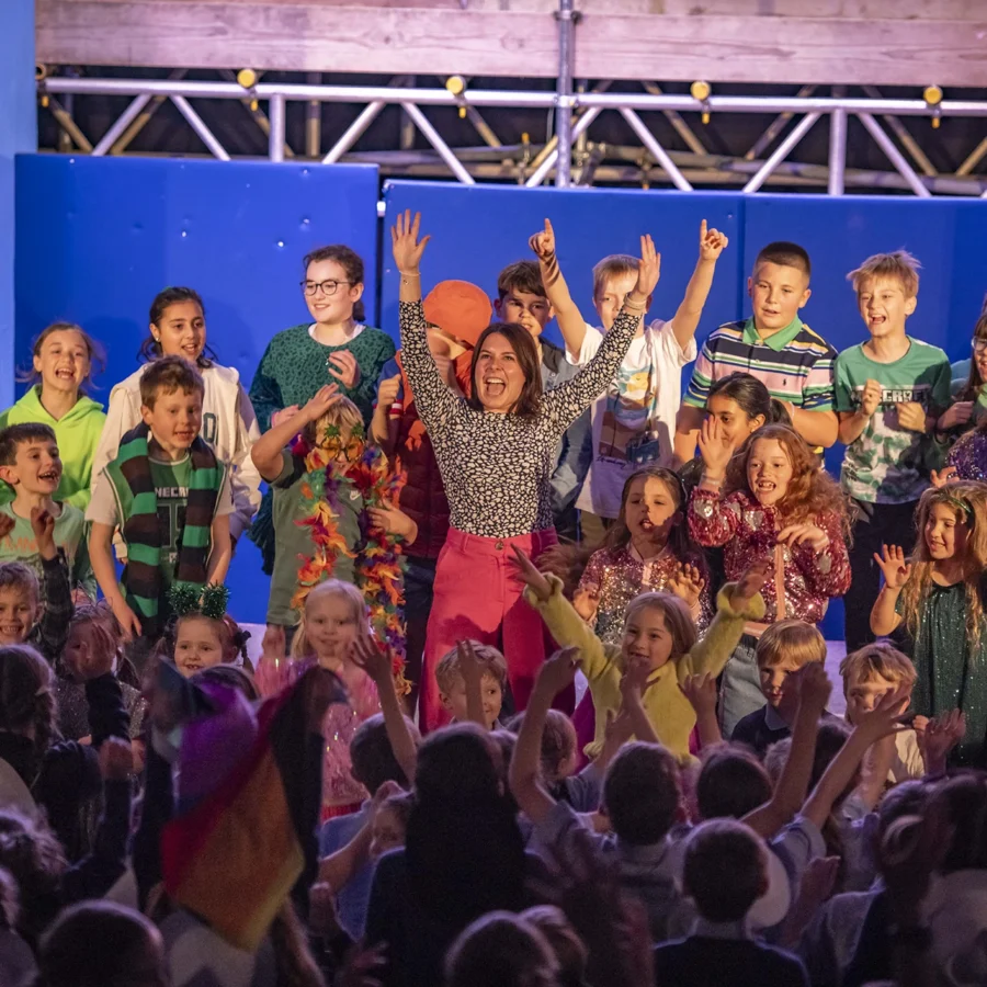 A teacher on stage with pupils during a production at Barnard Castle School.