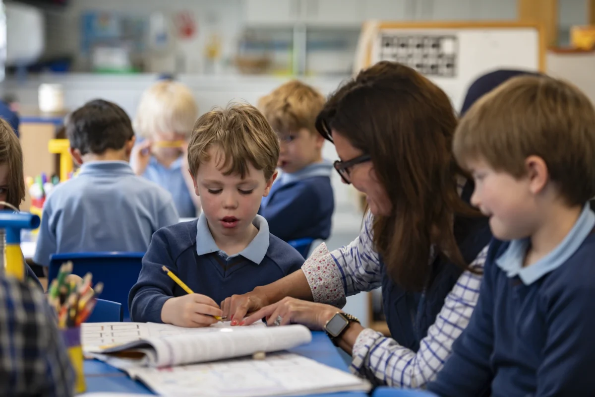 A Barnard Castle School teacher working with a Preppie in class.