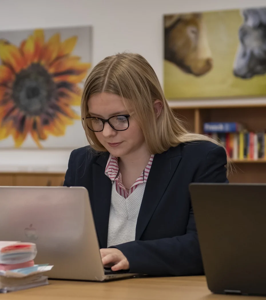 A female sixth form student studying on a laptop at Barnard Castle School.