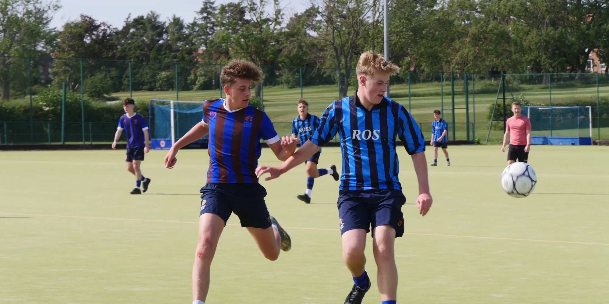 Barnard Castle School students in kit playing football.
