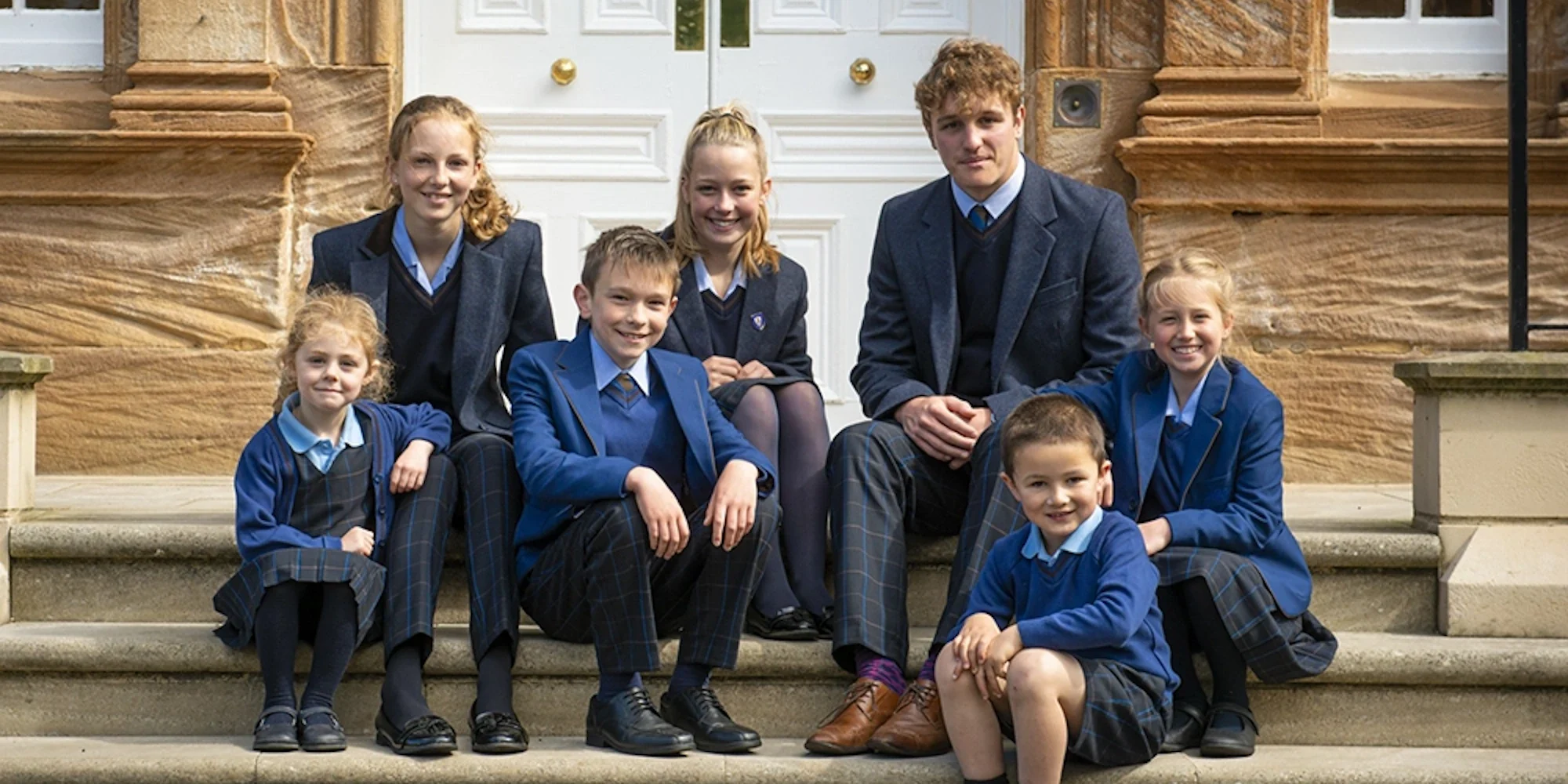 Barnard Castle School pupils sat on stairs.