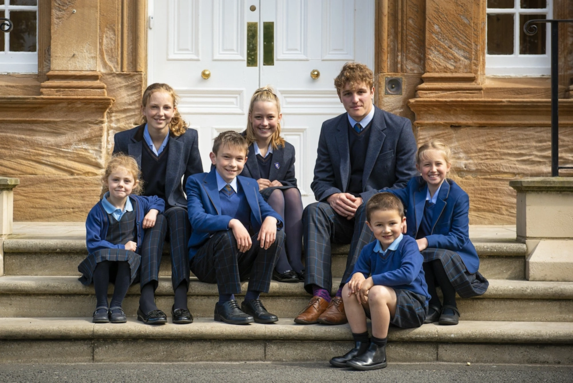 Barnard Castle School pupils sat on stairs.