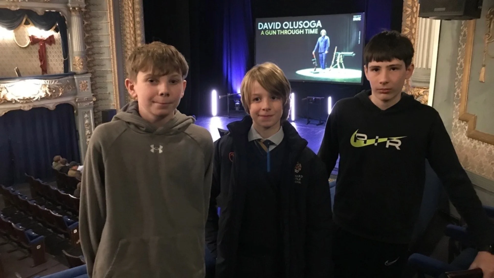 Three Barney students at the theatre for David Olusoga's A Gun Through Time.