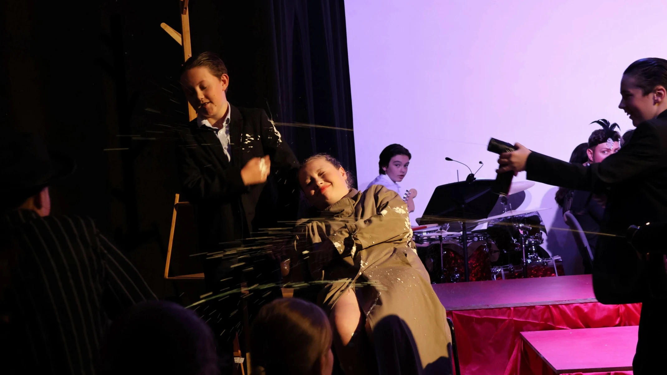 Students are shot with silly string during Bugsy Malone.