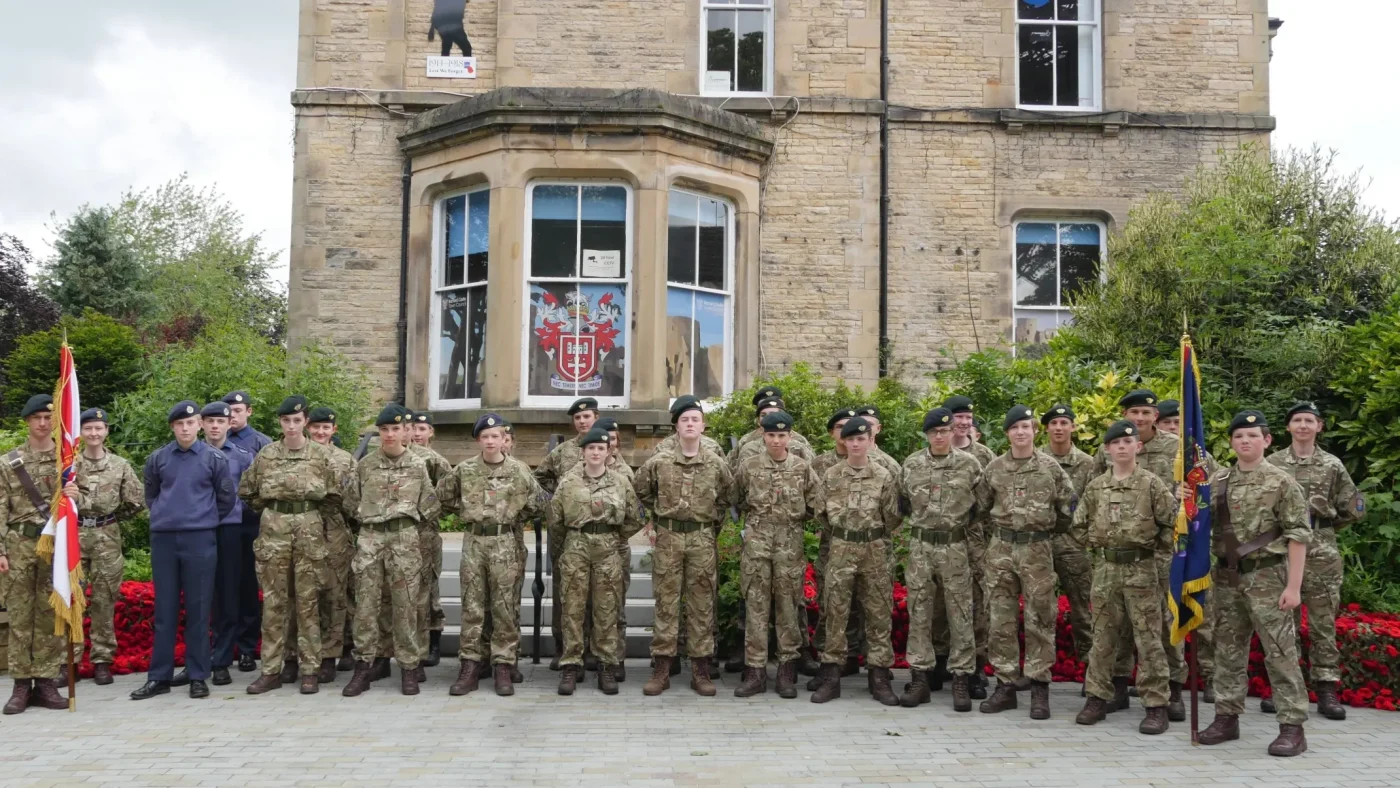 CCF cadets standing together in uniform.
