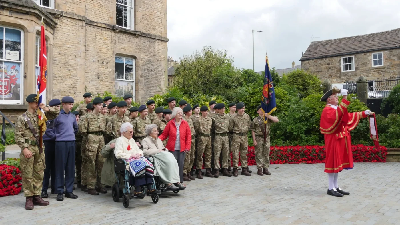 CCF cadets standing with the Town Crier.