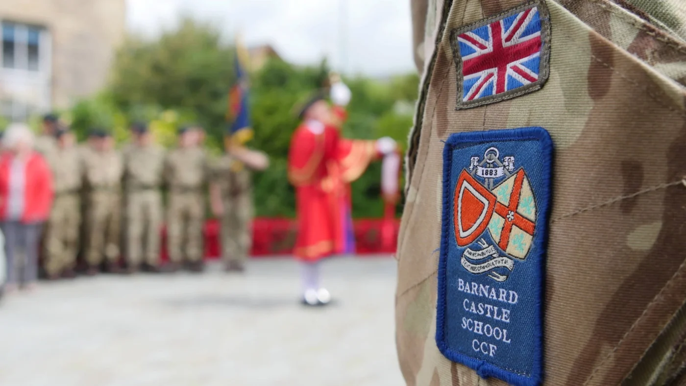 Union Flag and Barnard Castle patches on military fatigues.