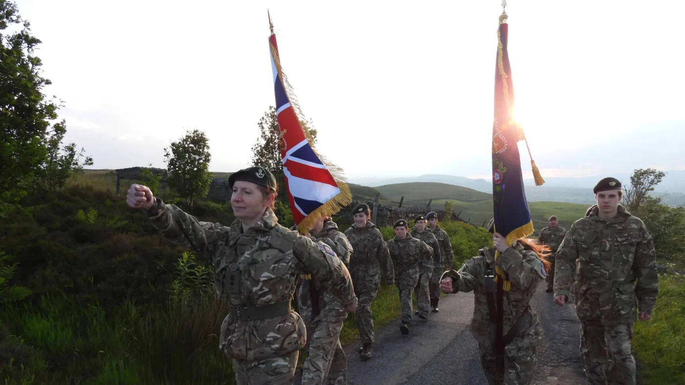 People in military uniform marching together.
