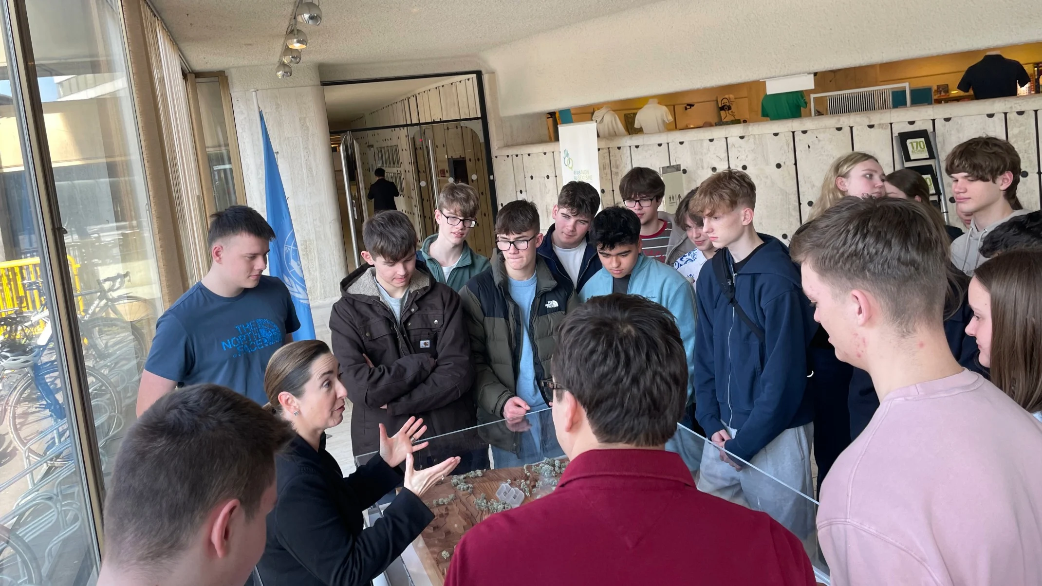 Barney students listening to a woman doing a demonstration.
