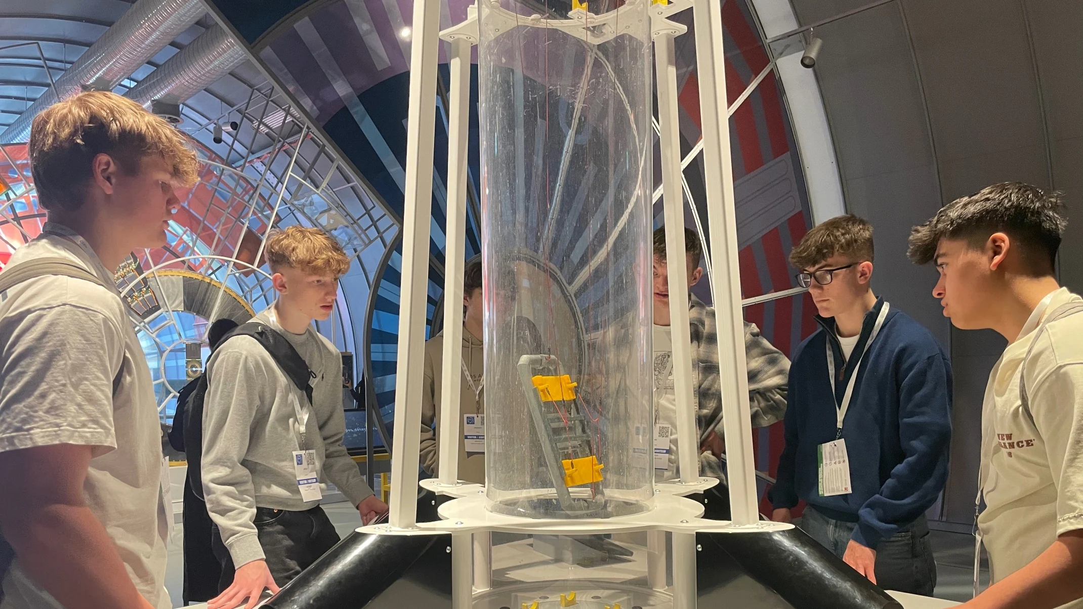Barney students gathered around a physics display.