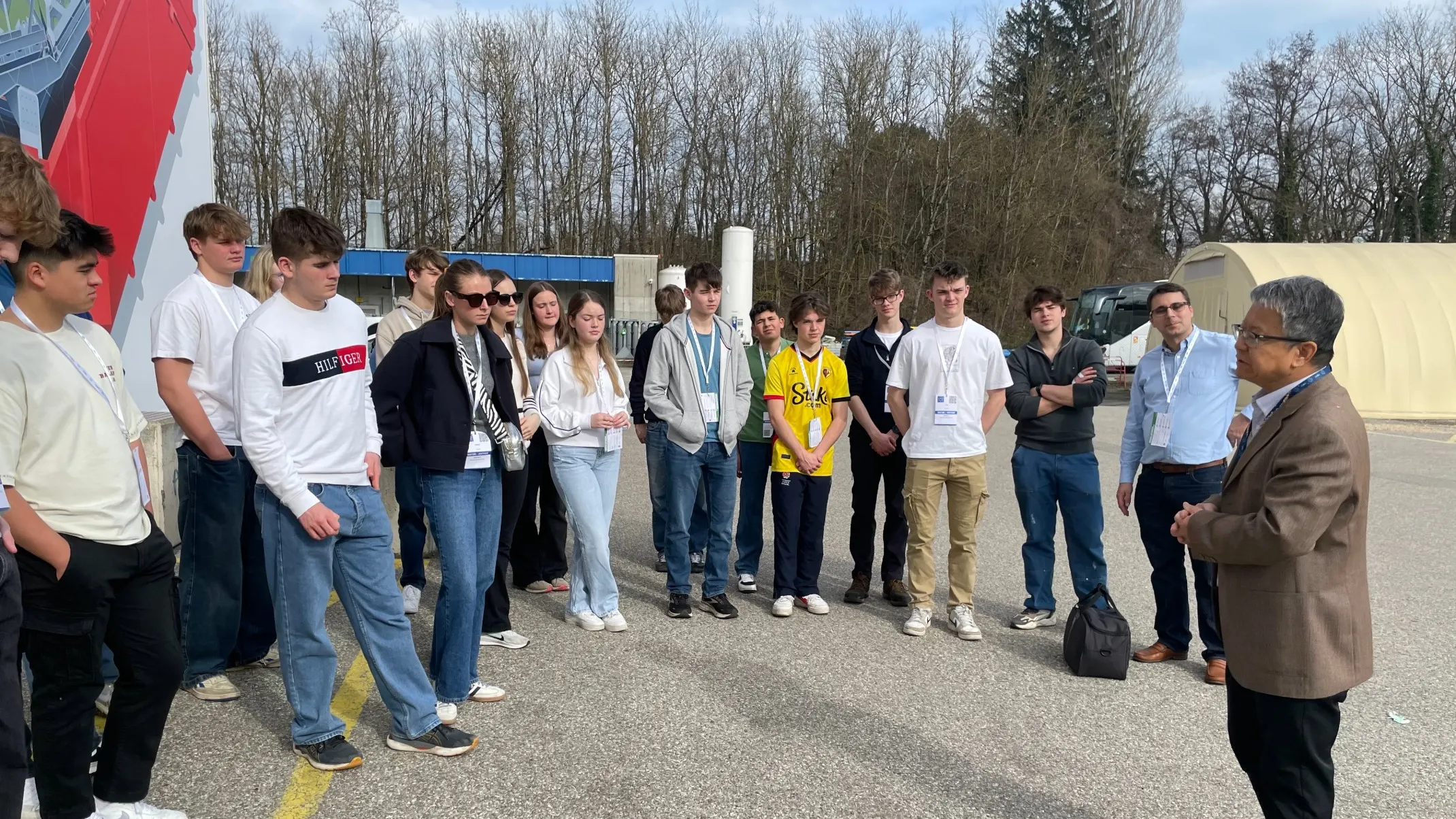 A group of Barney students listening to a man.