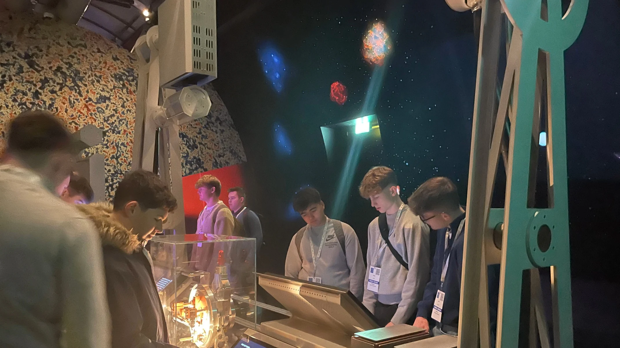 Barney students engaging with displays at CERN.