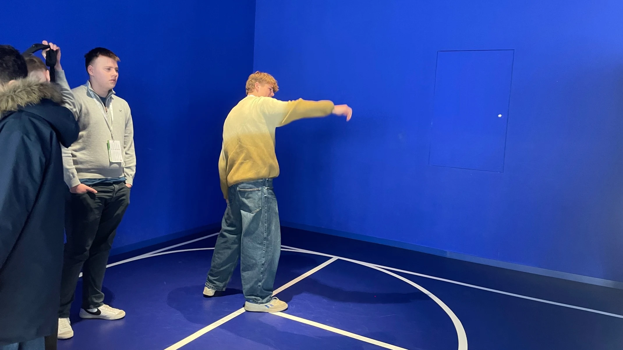 Barney students in a blue room at CERN.