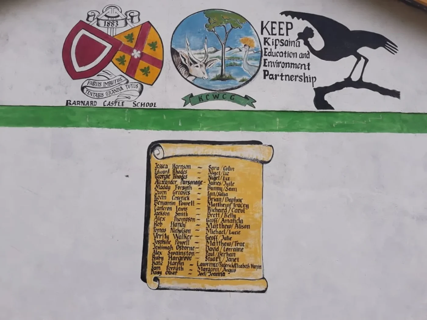 A wall painted with the KEEP and Barnard Castle School logos above a list of names.