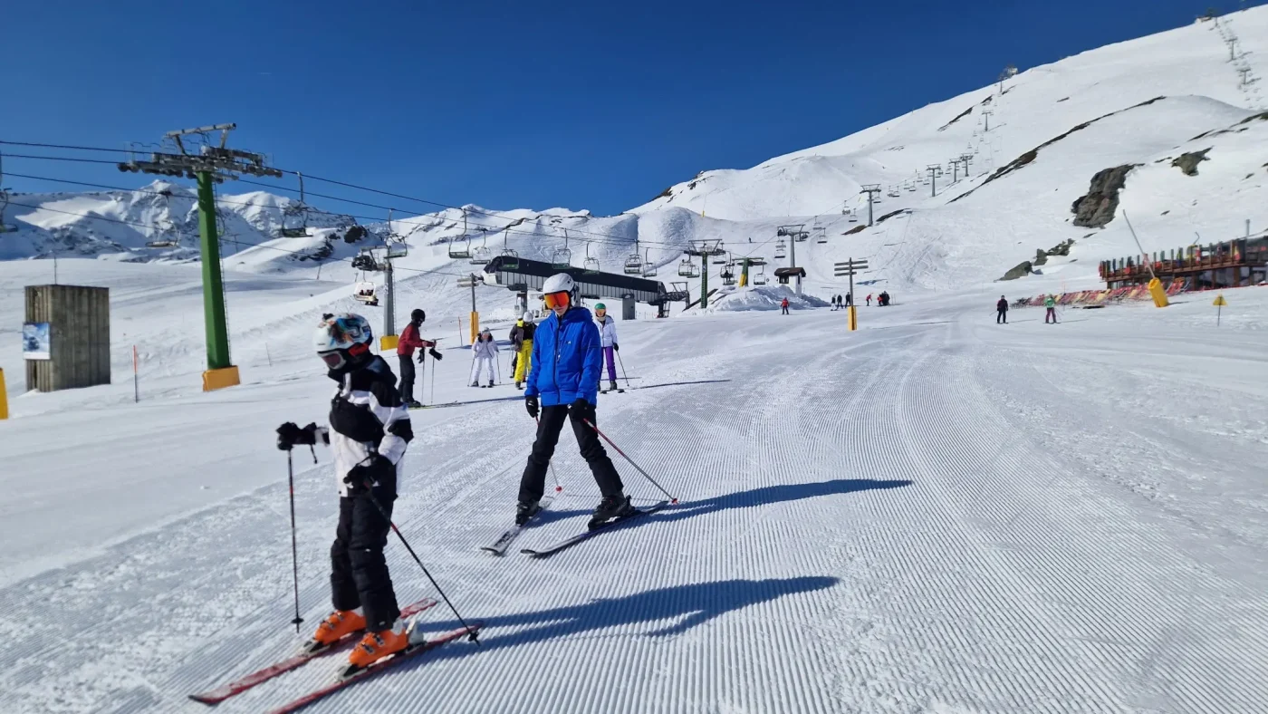 Two Barney students skiing past the camera.