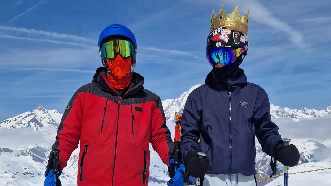 Two Barney students in full skiing gear, with one wearing a gold crown.