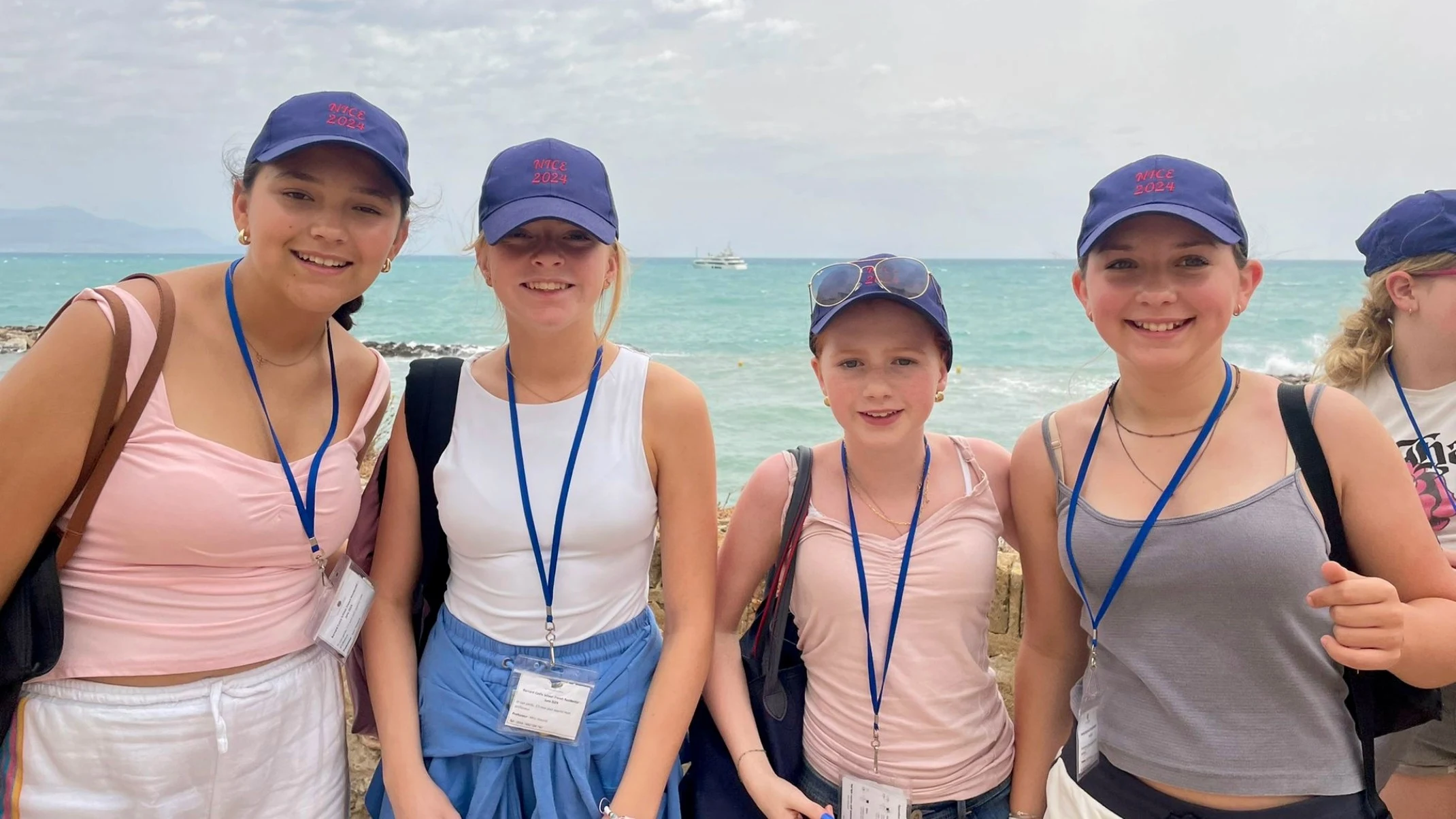 Barney girls standing in front of the ocean.
