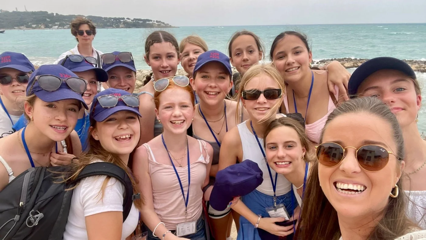 A large group of Barney girls stood on the seafront.