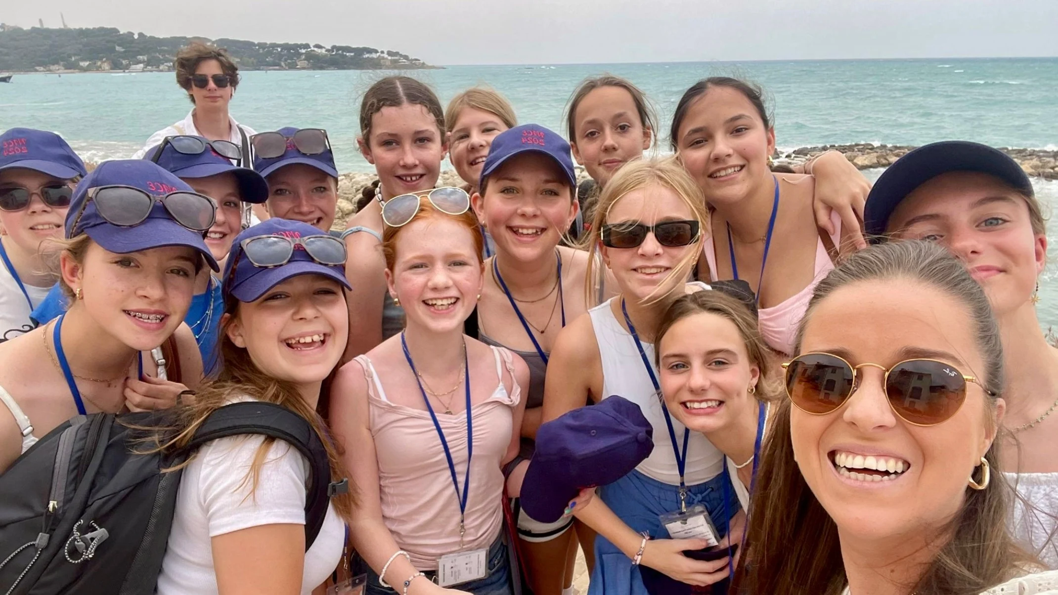 A large group of Barney girls stood on the seafront.