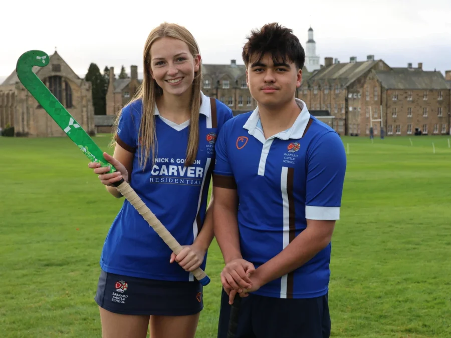 Male and female hockey students on Barnard Castle School field