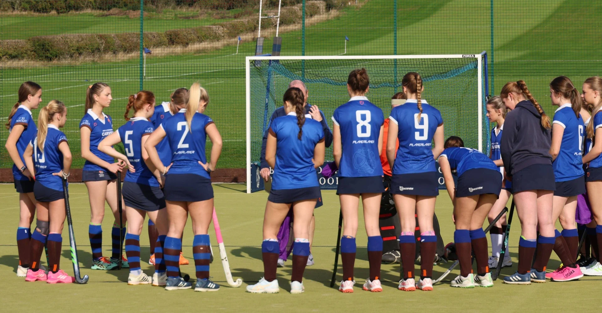 Hockey team huddle before a match.