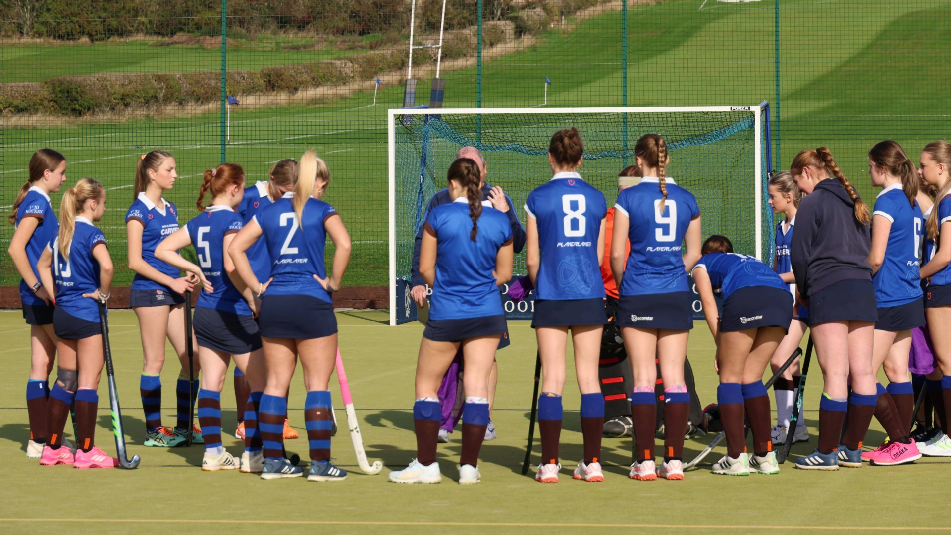 Hockey team huddle before a match.