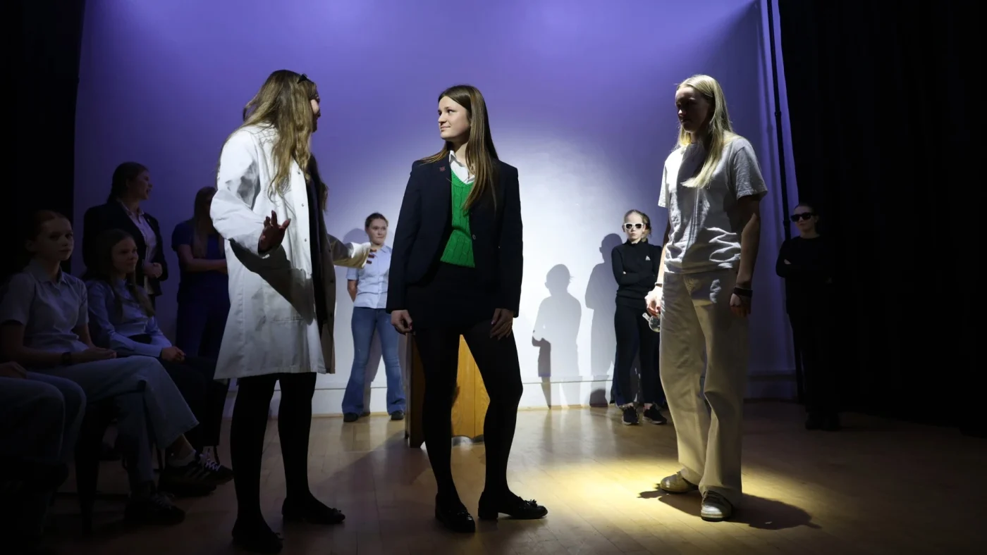 Three Barney girls standing performing.