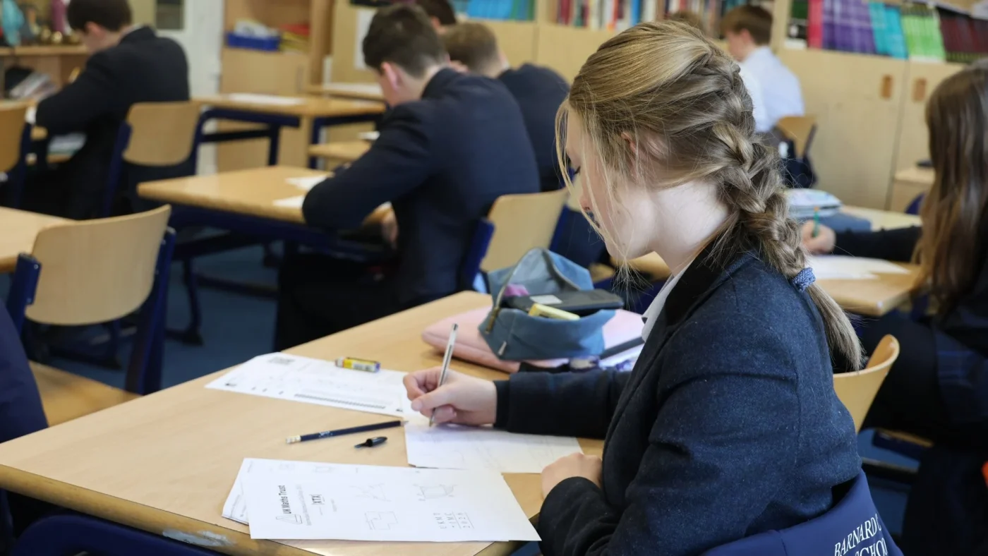 A Barney student doing calculations during the UKMT Intermediate Maths Challenge.