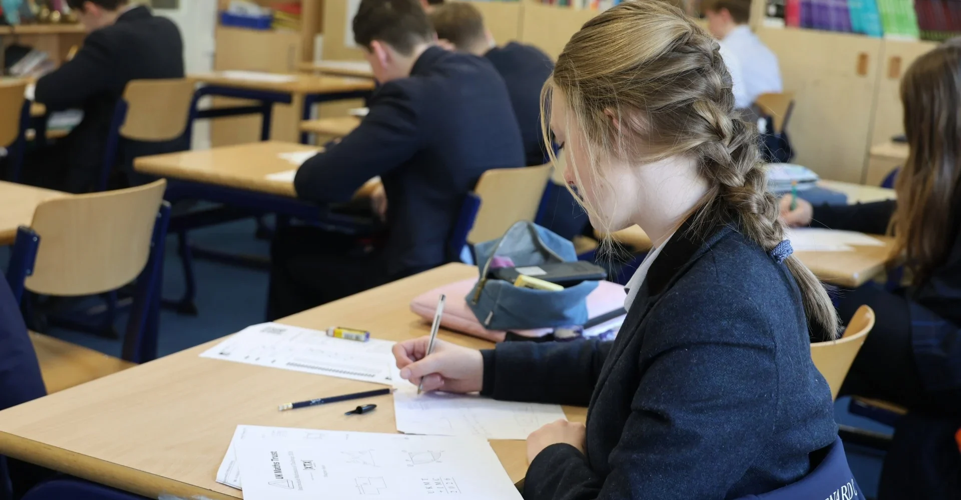 A Barney student doing calculations during the UKMT Intermediate Maths Challenge.