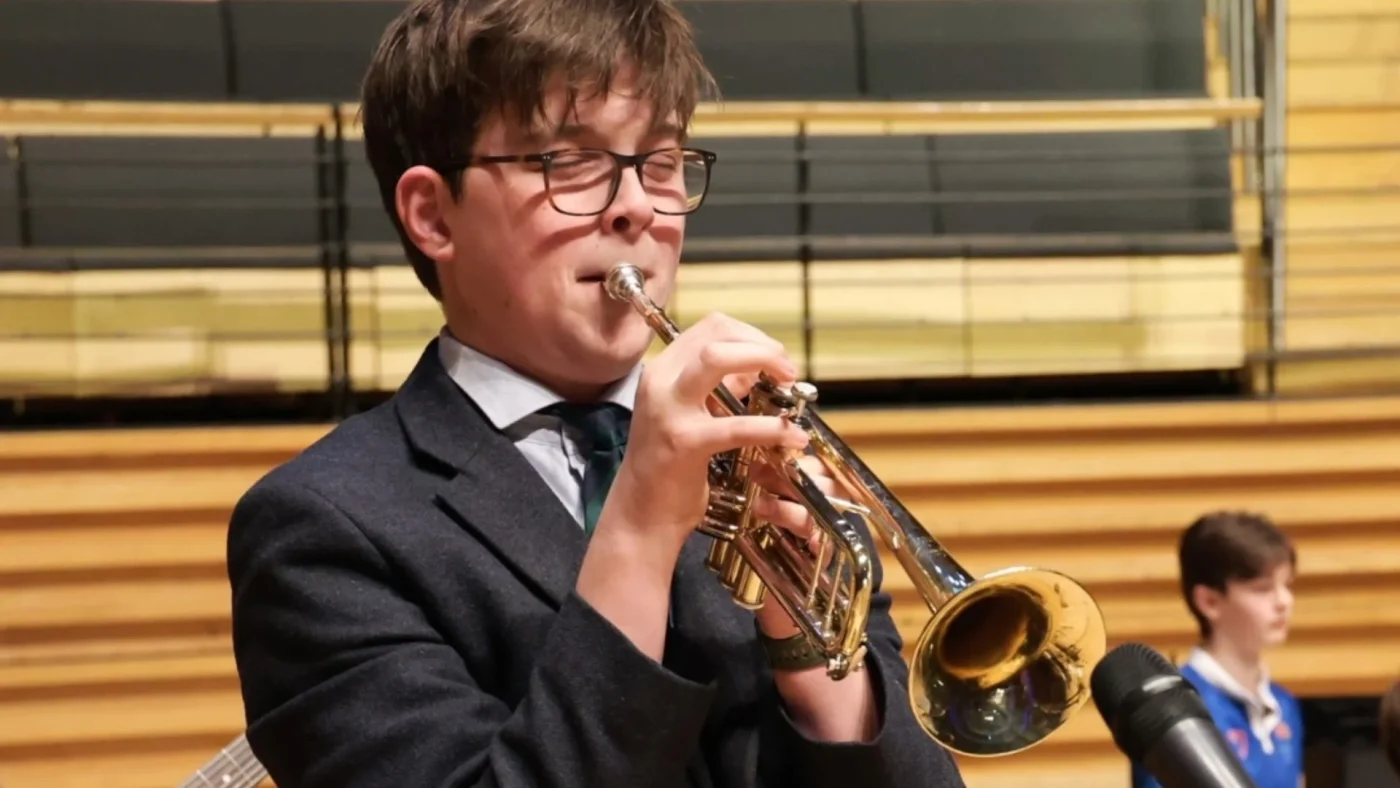 A Barney student playing the trumpet.