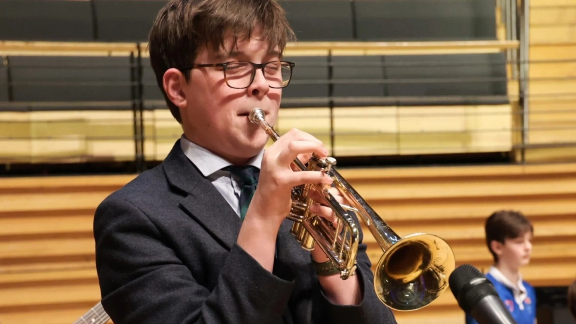 A Barney student playing the trumpet.
