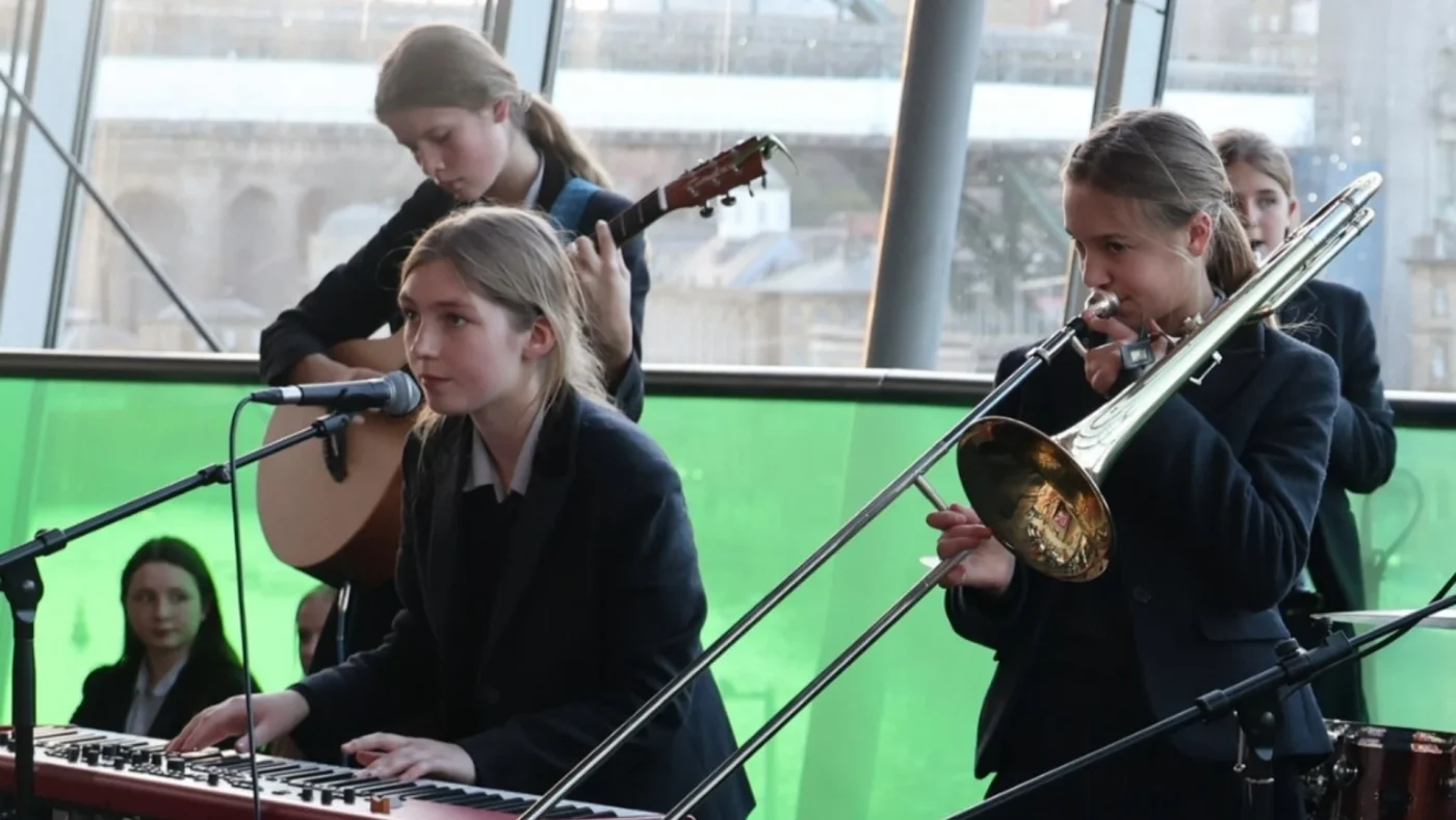 Barney students playing various instruments.