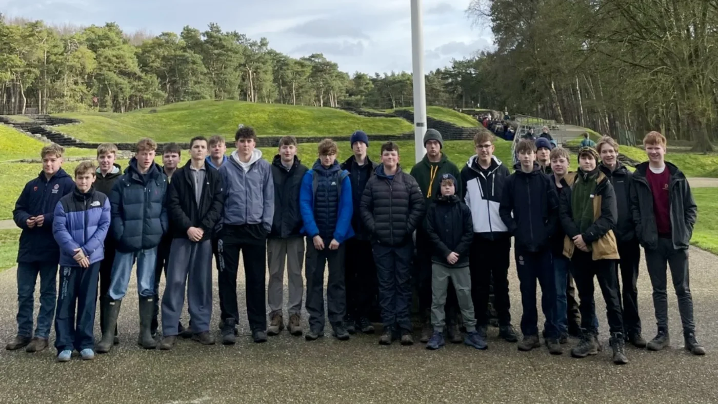 A large group of male Barney students standing in front of a flagpole.