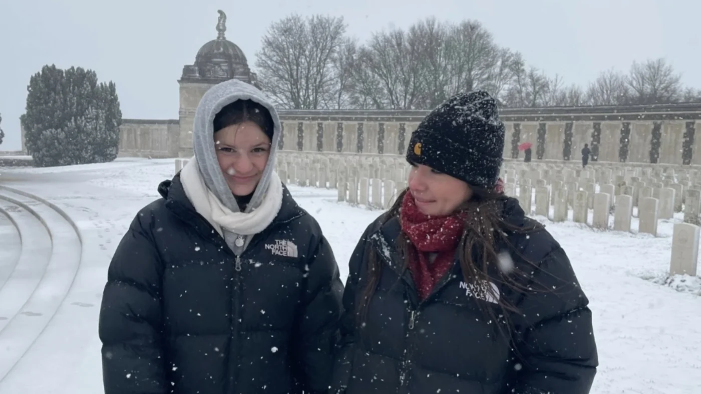 Two Barney students walking in the snow.