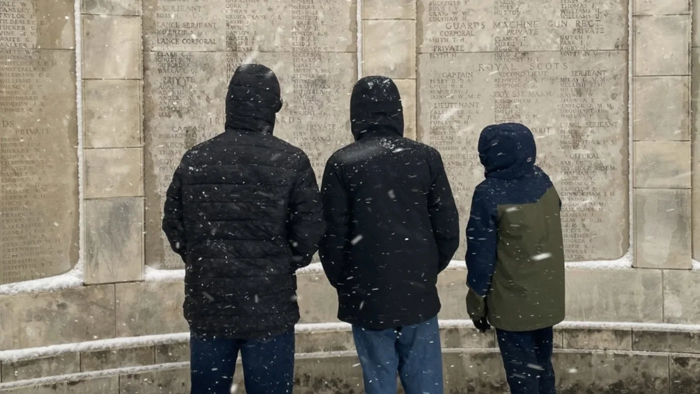 Three Barney students read the names on a WW1 monument.