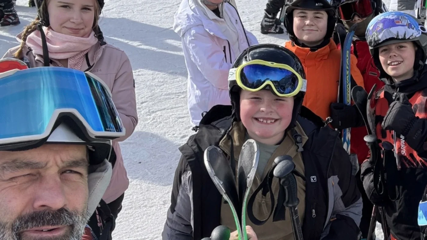 A Barney staff member takes a selfie with pupils in ski gear.