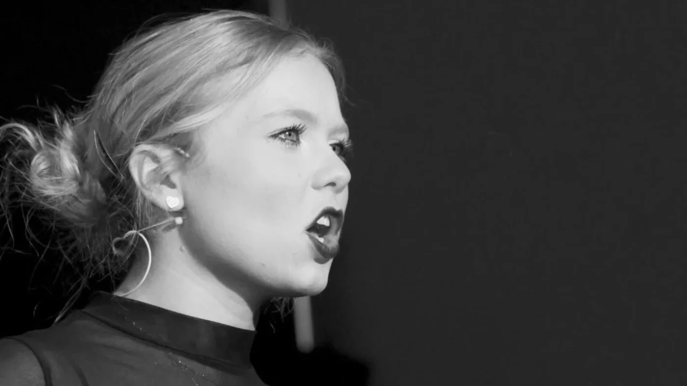 A Barney Senior School student singing in black and white.