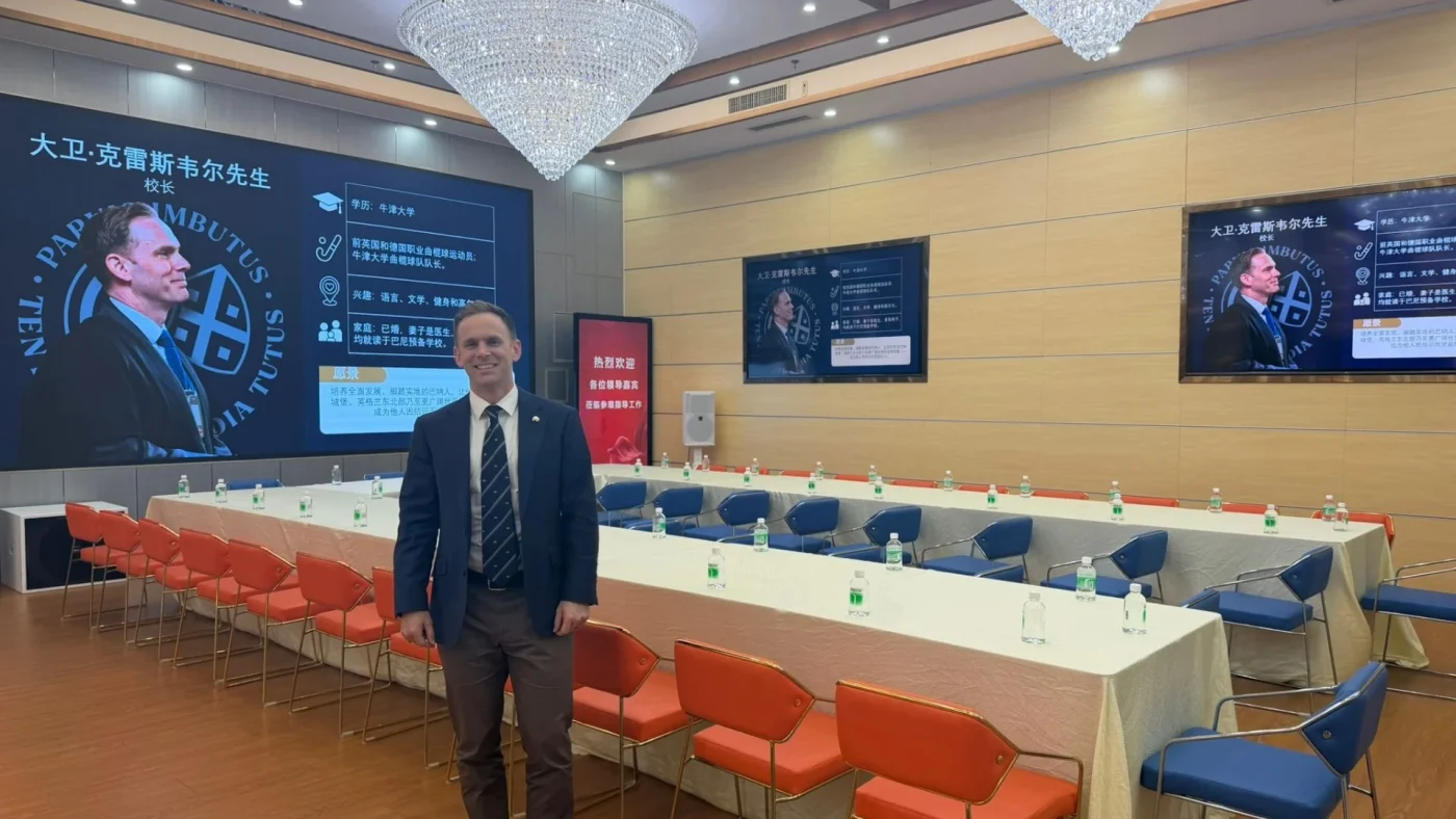 David Cresswell in a large conference room with glass chandaliers.