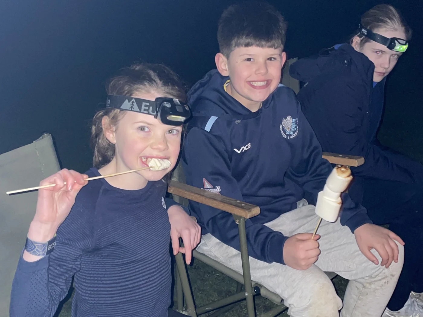 Students enjoying marshmallows during Great Tommy Sleep Out.