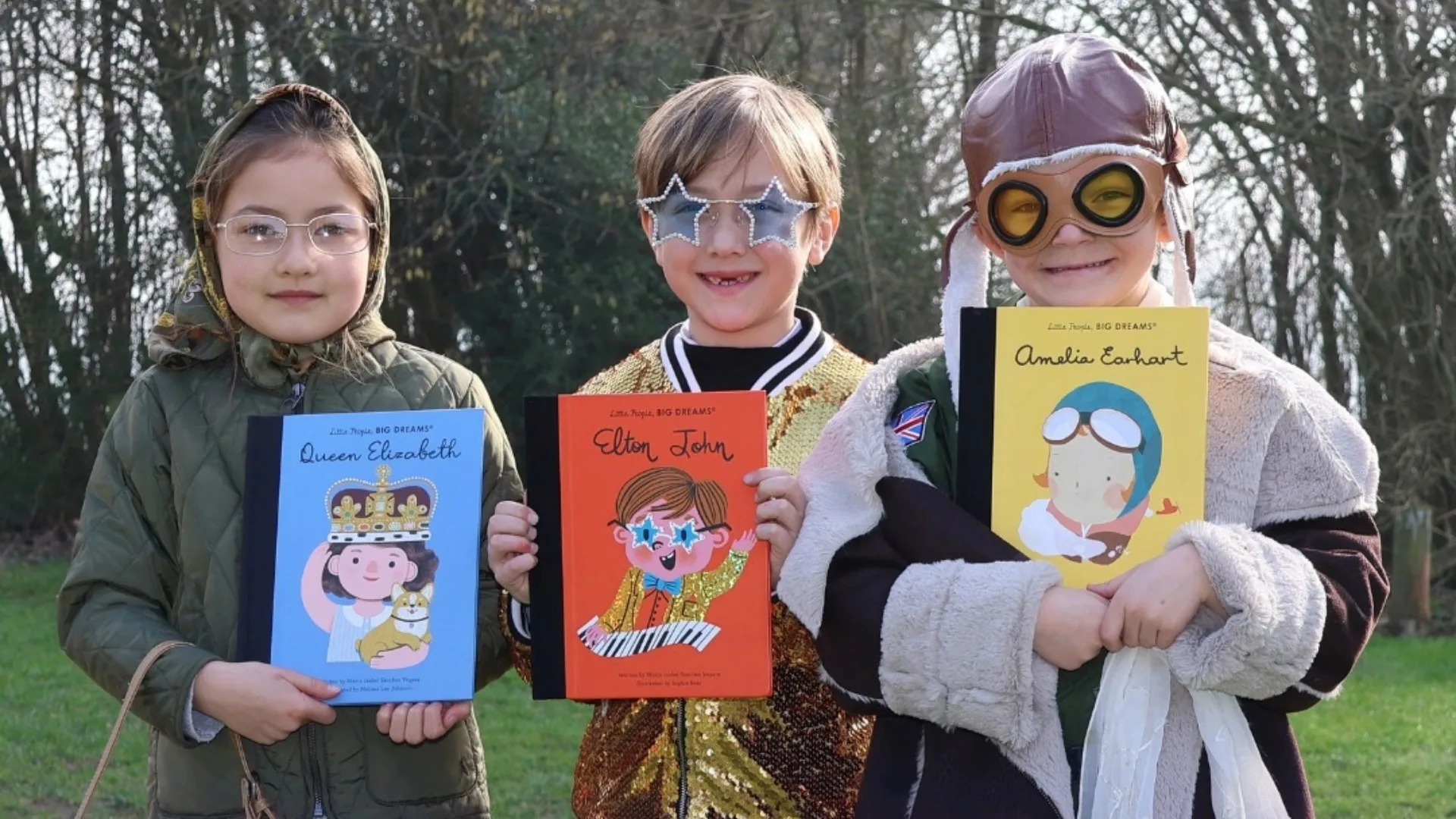Three Barney Prep students dressed as Queen Elizabeth, Elton John, and Amelia Earhart.