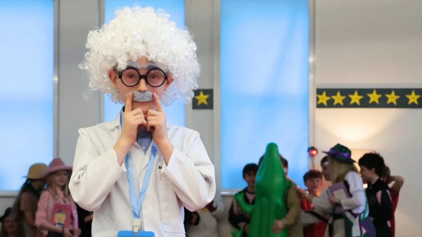 A Barney Prep student dressed as Albert Einstein on the catwalk.