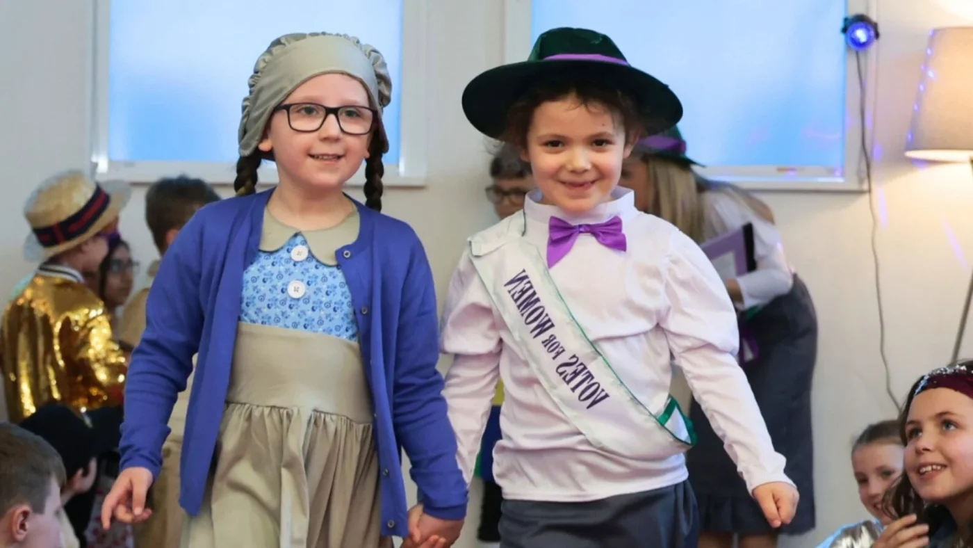 Two Barney Prep students in fancy dress on the catwalk.