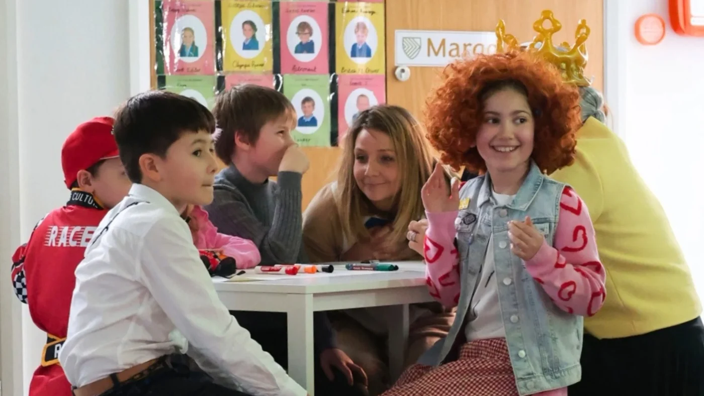 Barney Prep students sitting together in fancy dress for World Book Day.